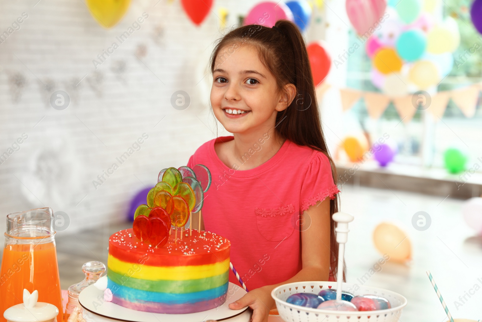 Photo of Happy girl in room decorated for birthday party