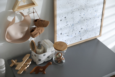 Photo of Wooden toys and different accessories on grey table in child room