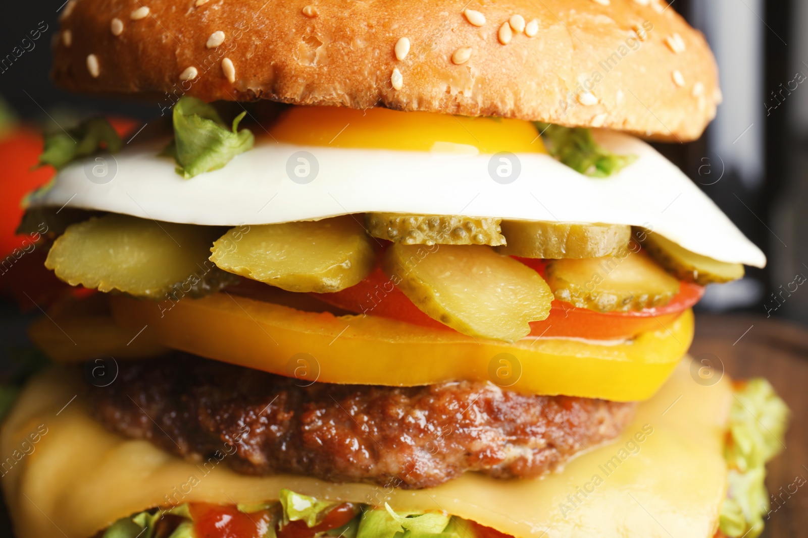 Photo of Closeup view of tasty burger with fried egg