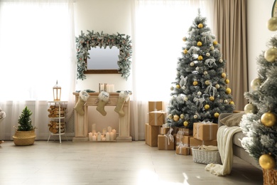 Photo of Stylish Christmas interior with beautiful decorated tree and fireplace