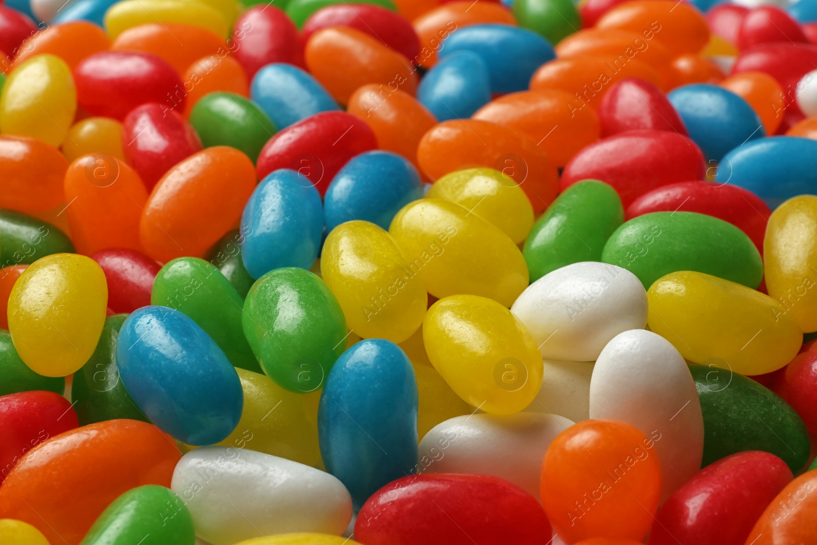 Photo of Tasty bright jelly beans as background, closeup