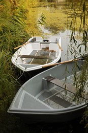 Photo of Modern boats with wooden oars on lake