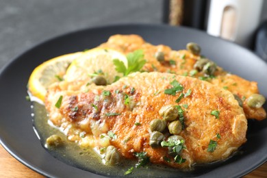 Photo of Delicious chicken piccata with herbs on table, closeup