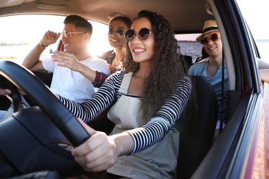 Photo of Happy friends together in car on road trip