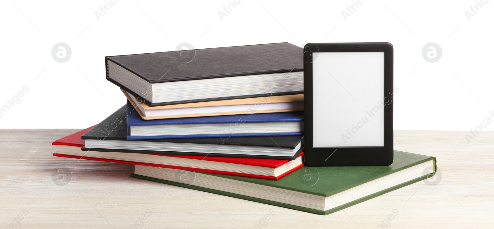 Photo of Stack of hardcover books and modern e-book on wooden table against white background