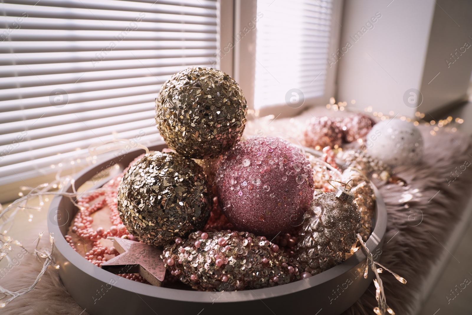 Photo of Beautiful Christmas tree baubles on window sill indoors, closeup