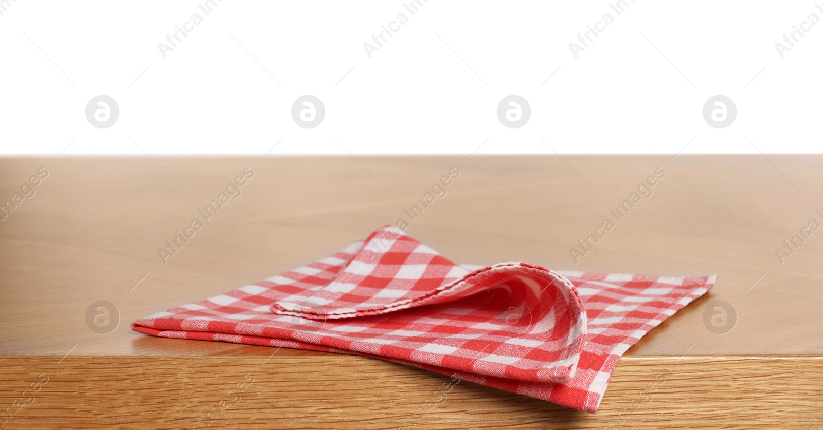 Photo of Checkered tablecloth on wooden table against white background