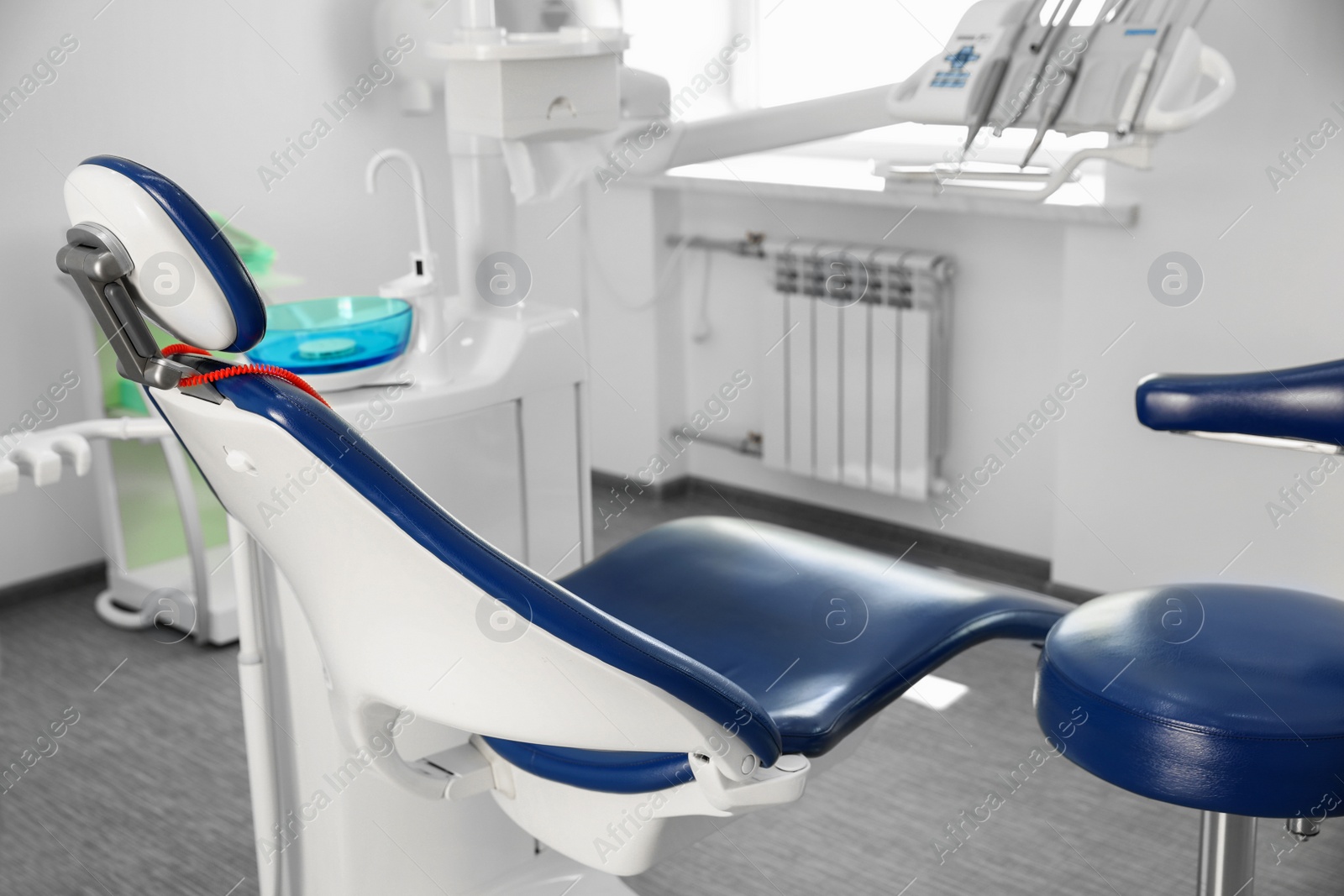 Photo of Dentist's office interior with modern chair and equipment