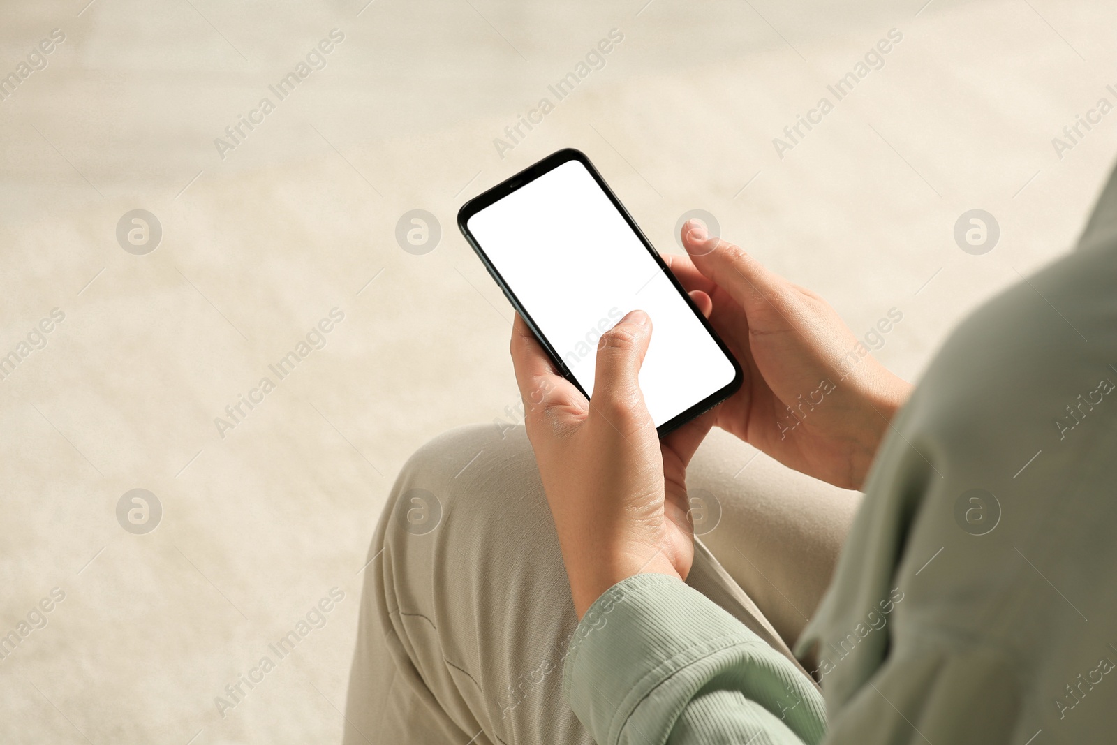 Photo of Young woman using smartphone indoors, closeup view