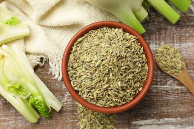 Fennel seeds and fresh stalks on wooden table, flat lay