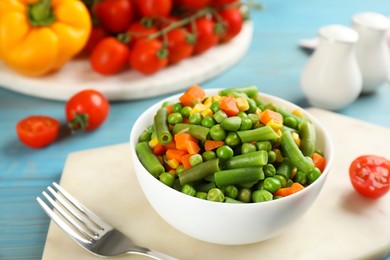 Photo of Mix of fresh vegetables served on light blue wooden table