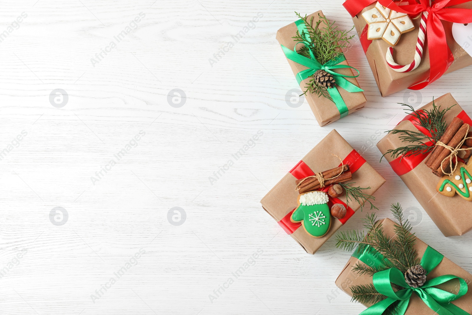 Photo of Flat lay composition with Christmas gift boxes on white wooden background. Space for text