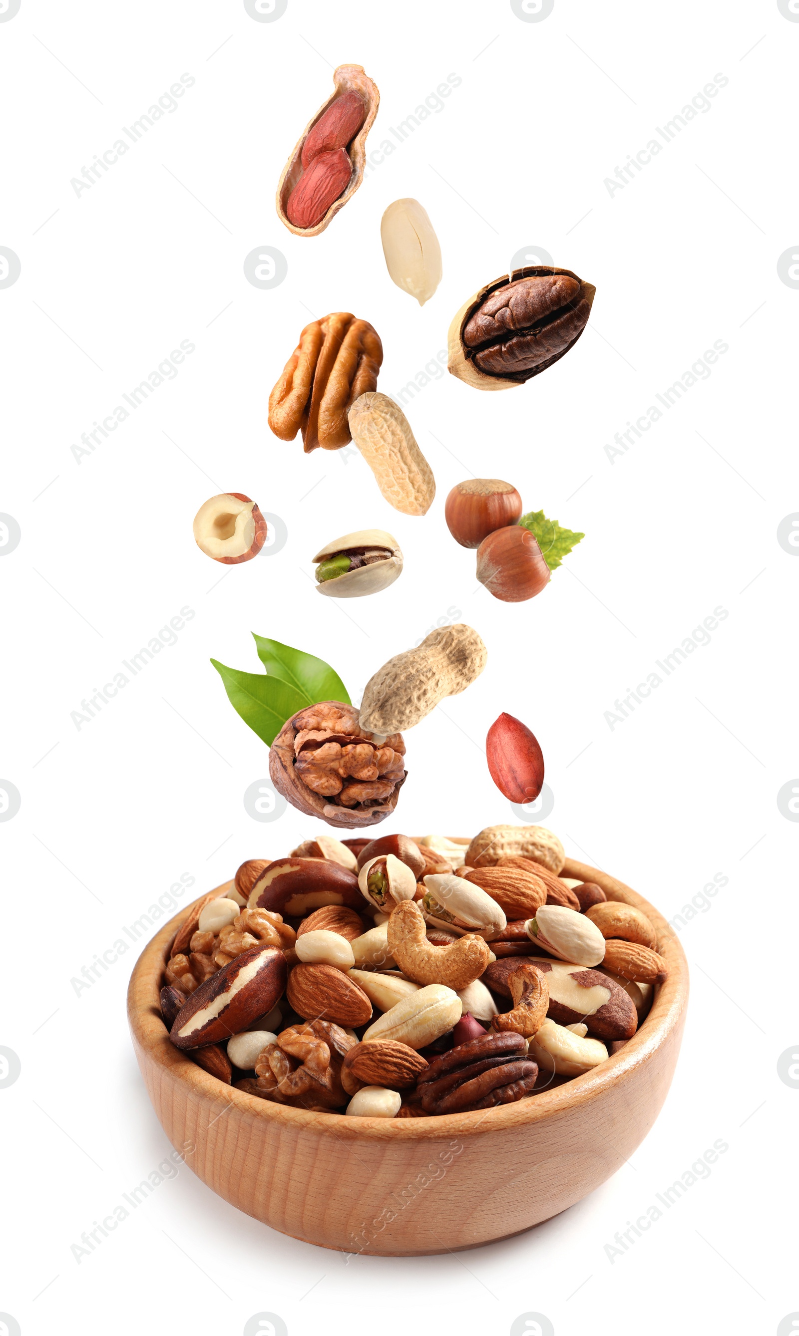 Image of Different nuts falling into bowl on white background