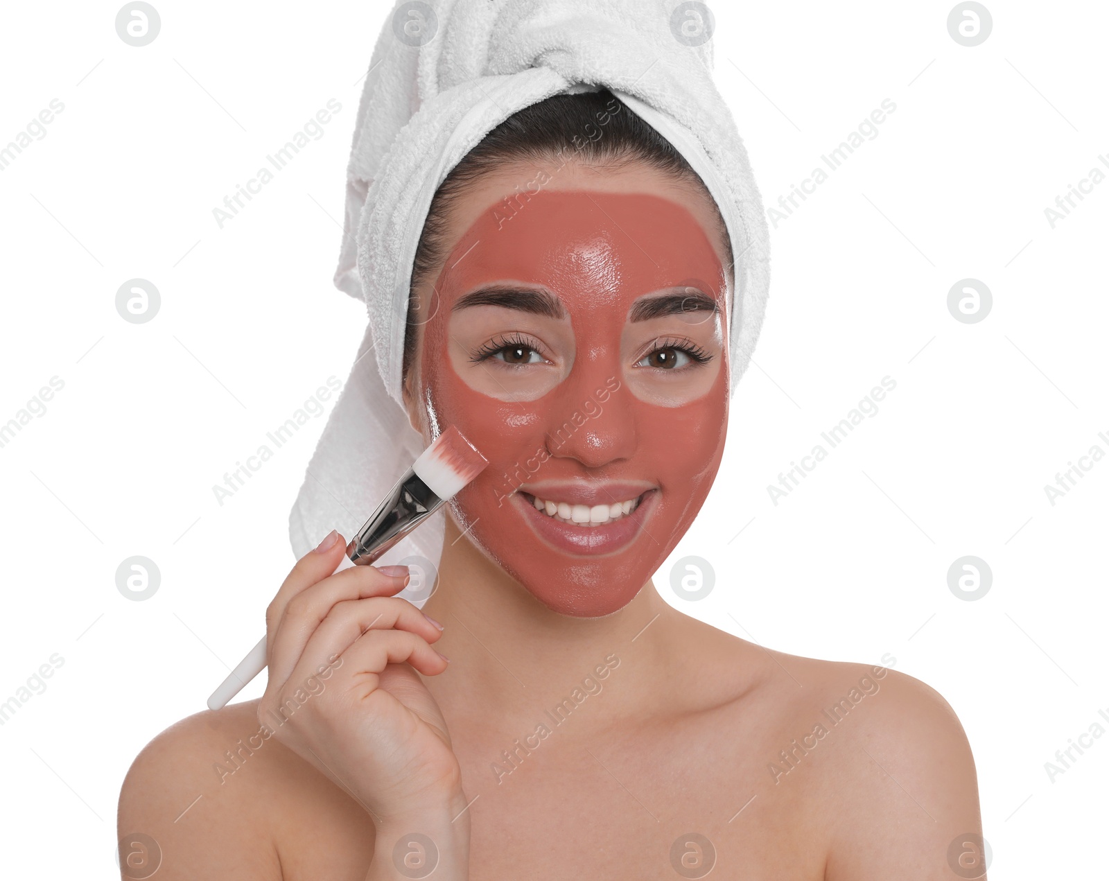 Photo of Woman applying pomegranate face mask on white background