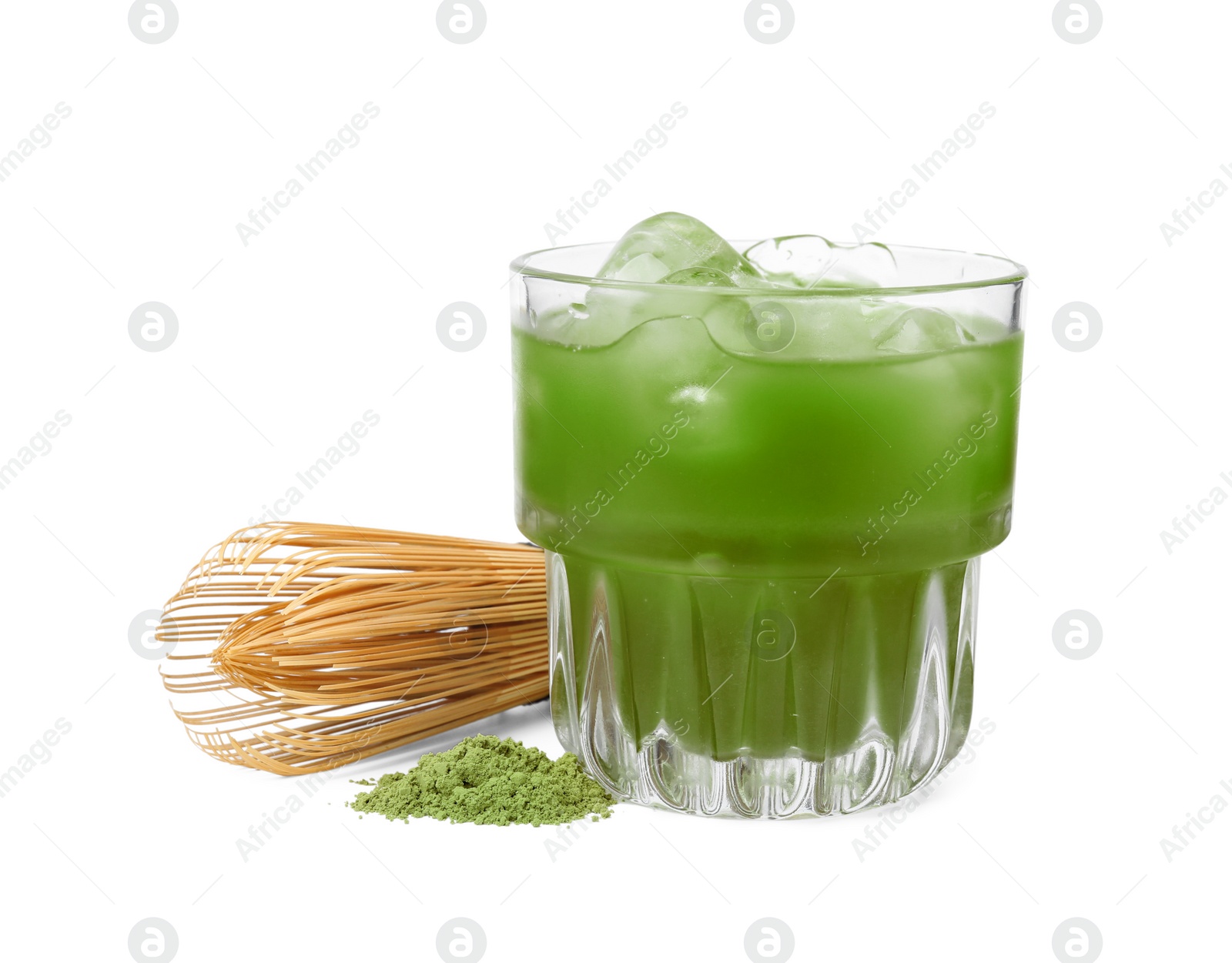 Photo of Glass of delicious iced green matcha tea, powder and bamboo whisk isolated on white