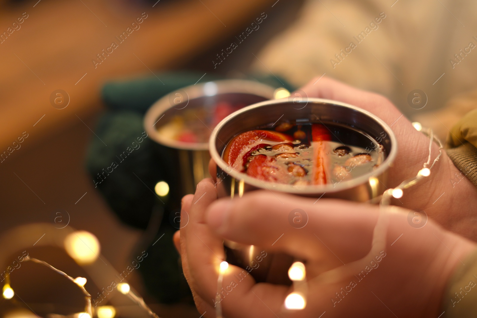 Photo of Couple with cups of tasty mulled wine, closeup