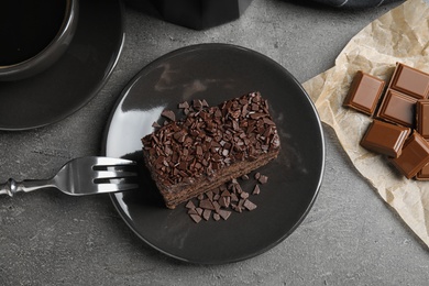 Photo of Delicious fresh chocolate cake served on grey table, flat lay