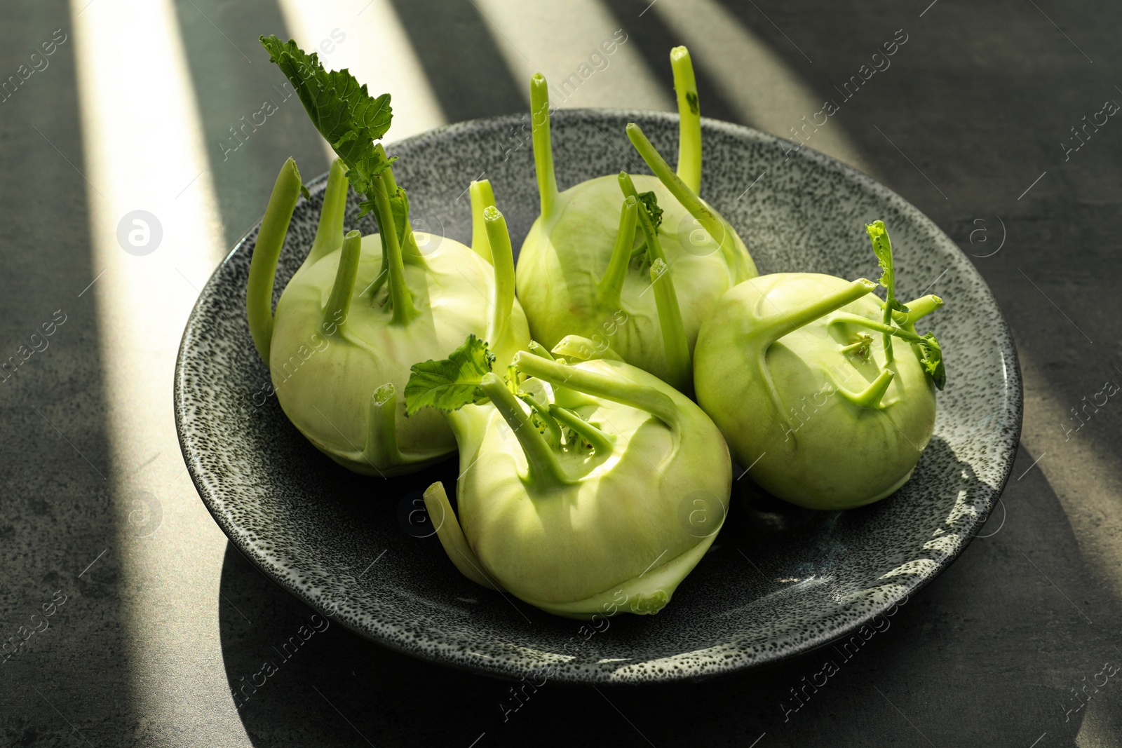 Photo of Whole ripe kohlrabi plants on grey table