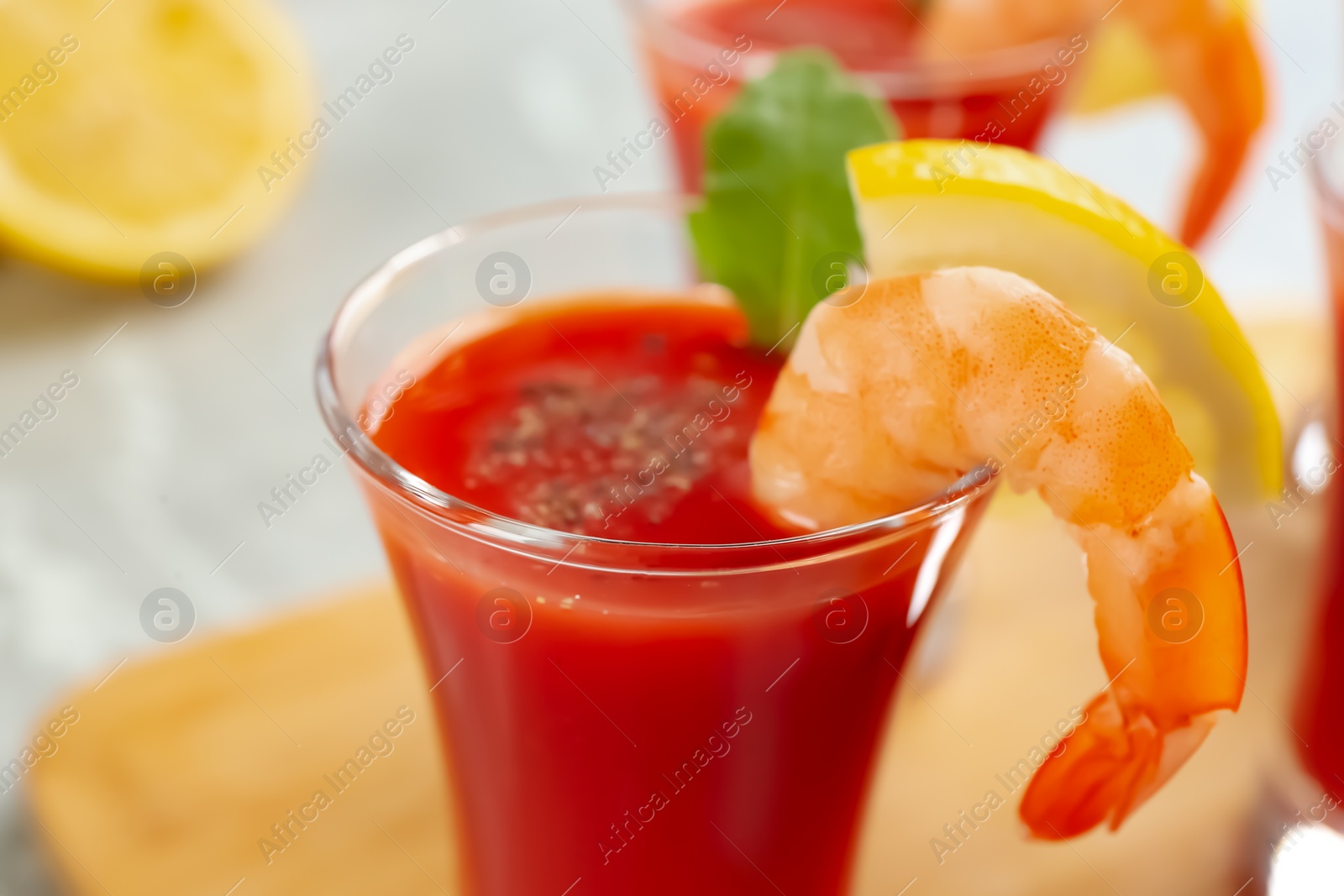 Photo of Delicious shrimp cocktail with tomato sauce served on table, closeup