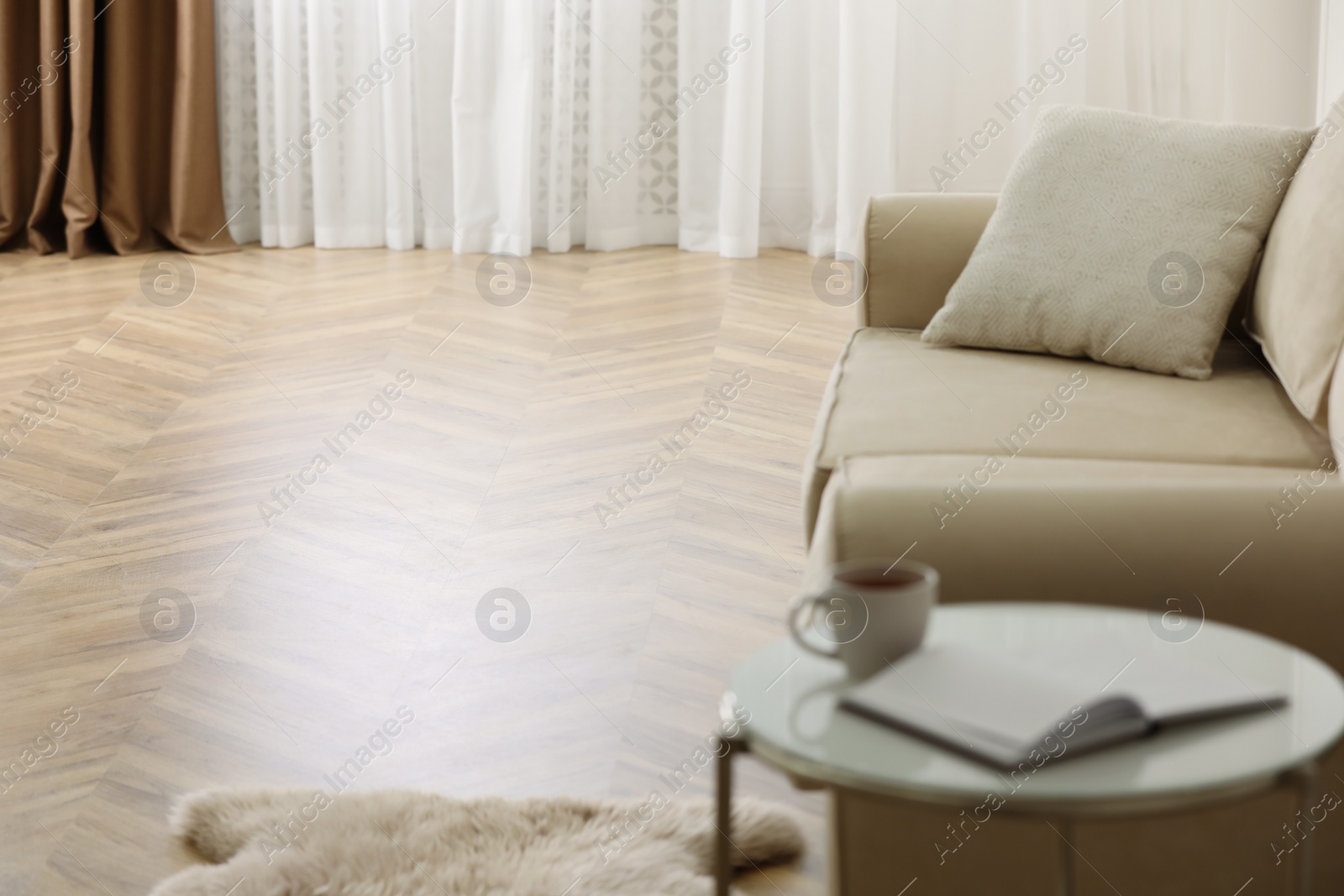 Photo of Parquet floor in room with sofa and coffee table