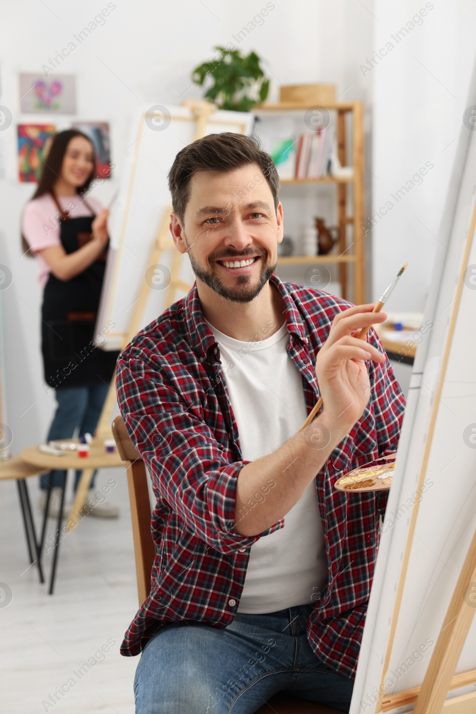 Photo of Students attending painting class in studio. Creative hobby