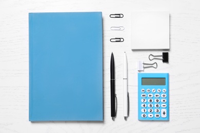 Different school stationery on white wooden table, flat lay