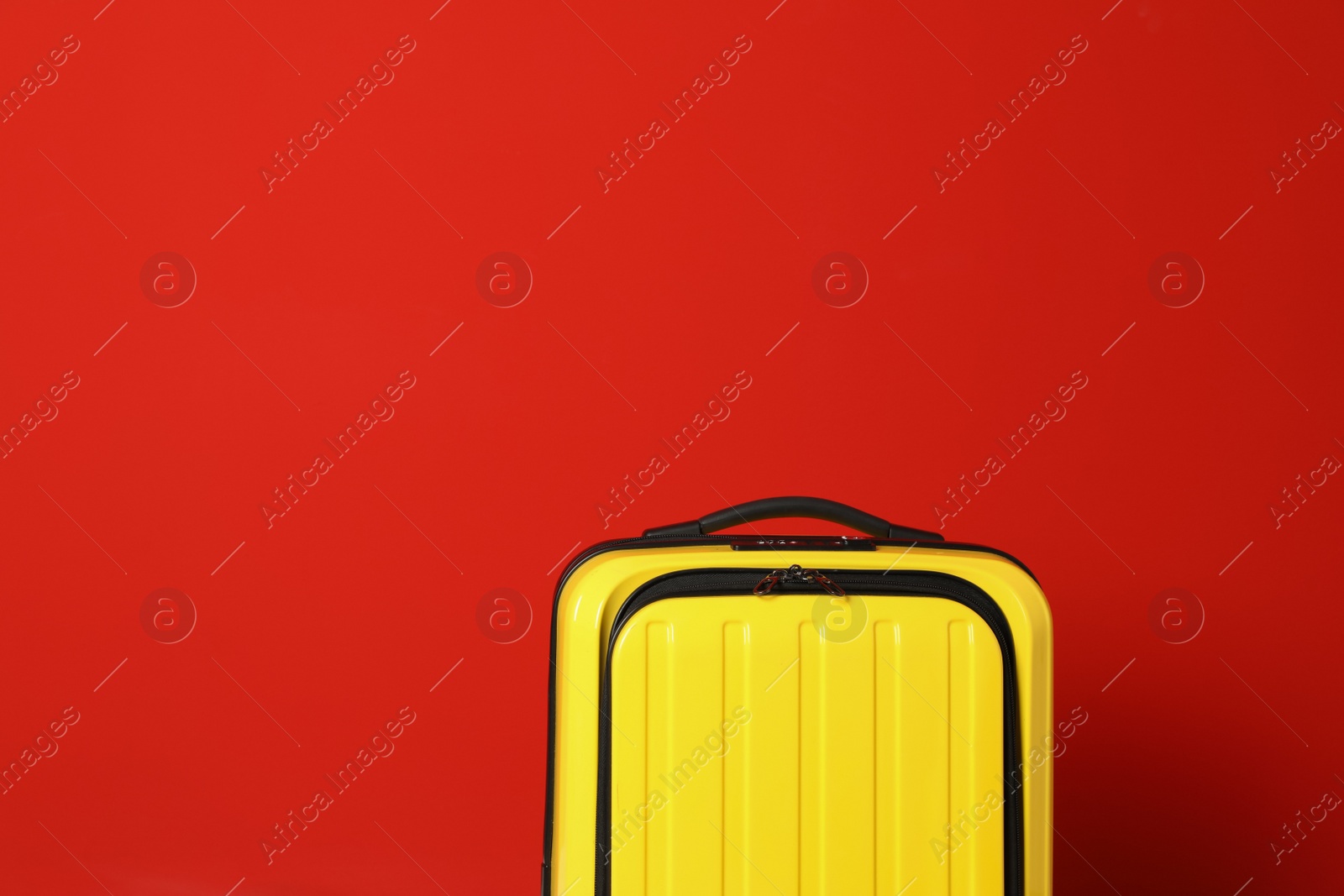 Photo of Stylish suitcase against color background, space for text