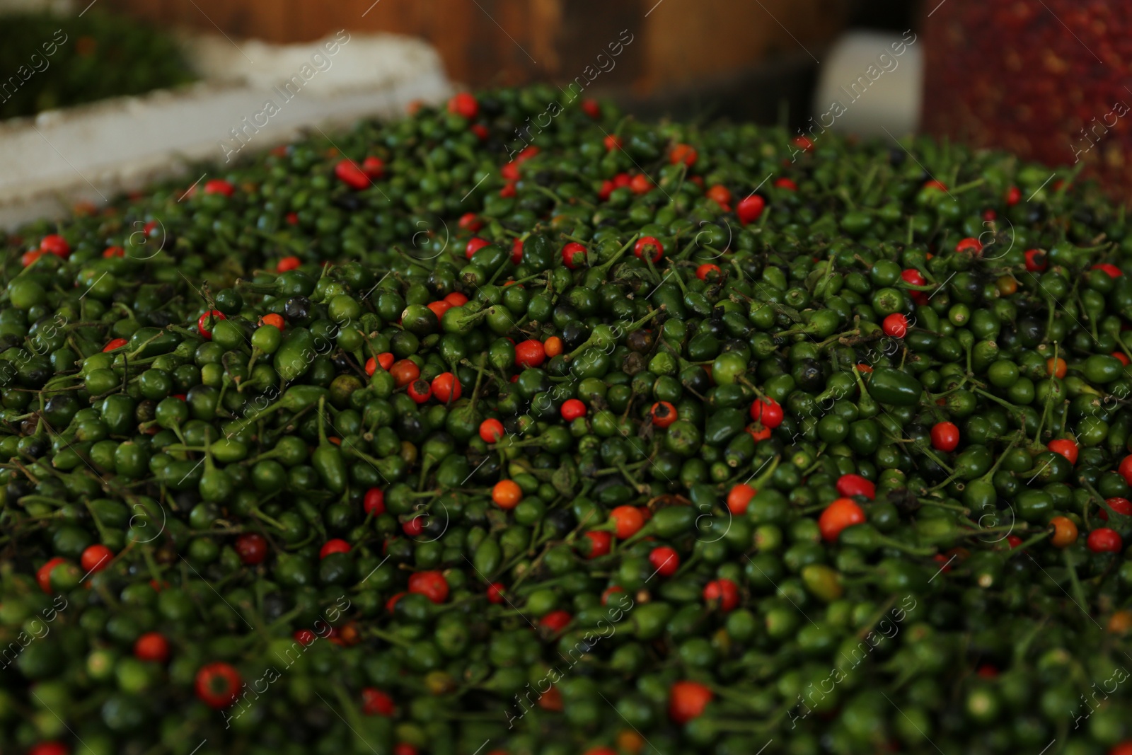 Photo of Heap of fresh delicious chiltepin on counter at market