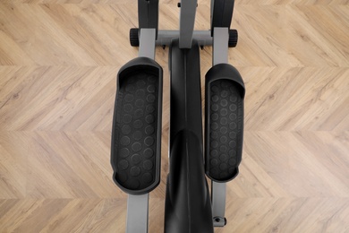 Modern elliptical machine cross trainer on floor, top view