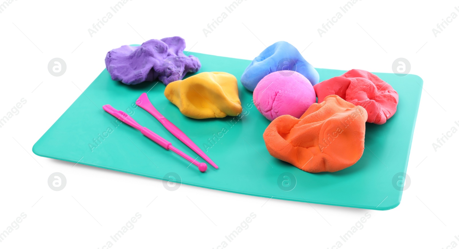 Photo of Board with plasticine and tools on white background