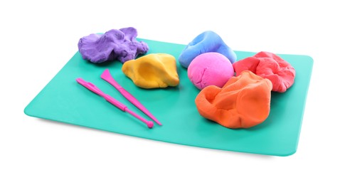 Board with plasticine and tools on white background