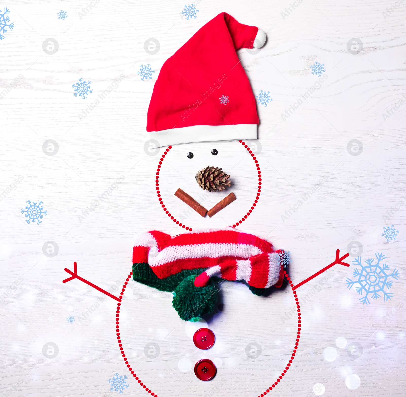 Image of Snowman with Santa hat and scarf on white wooden background, flat lay. Bokeh effect