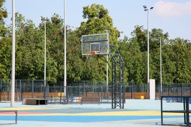 Photo of Empty basketball court with backboard outdoors on sunny day