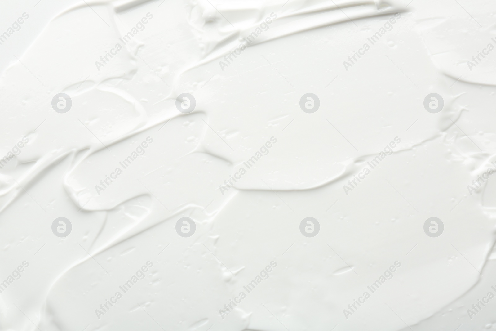 Photo of Texture of face care cream as background, top view