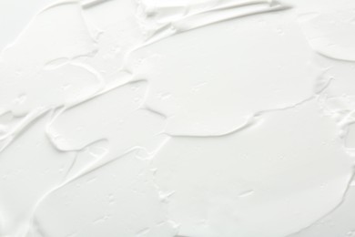 Photo of Texture of face care cream as background, top view