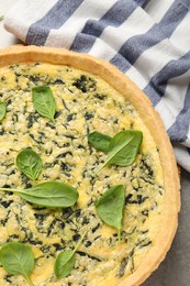 Delicious homemade spinach pie on light grey table, top view