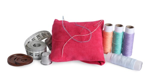 Pincushion, sewing needles, spools of threads, measuring tape, thimble and buttons isolated on white