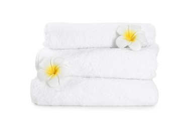 Photo of Terry towels and plumeria flowers isolated on white