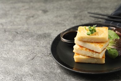 Photo of Delicious turnip cake with herbs served on grey table. Space for text