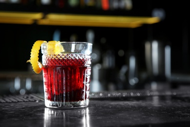 Photo of Fresh alcoholic Red Russian cocktail on bar counter. Space for text