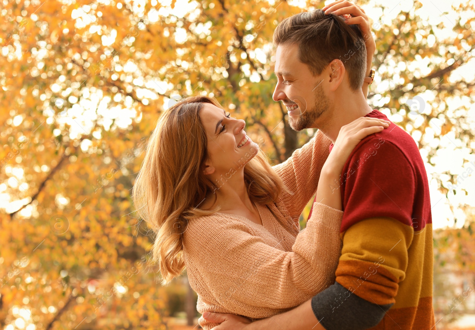 Photo of Lovely couple spending time together in park. Autumn walk