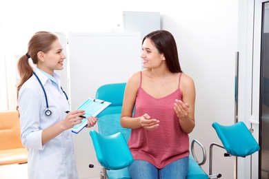 Photo of Young woman having appointment at gynecologist office