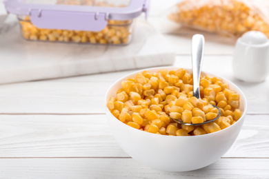 Frozen sweet corn on white wooden table. Vegetable preservation