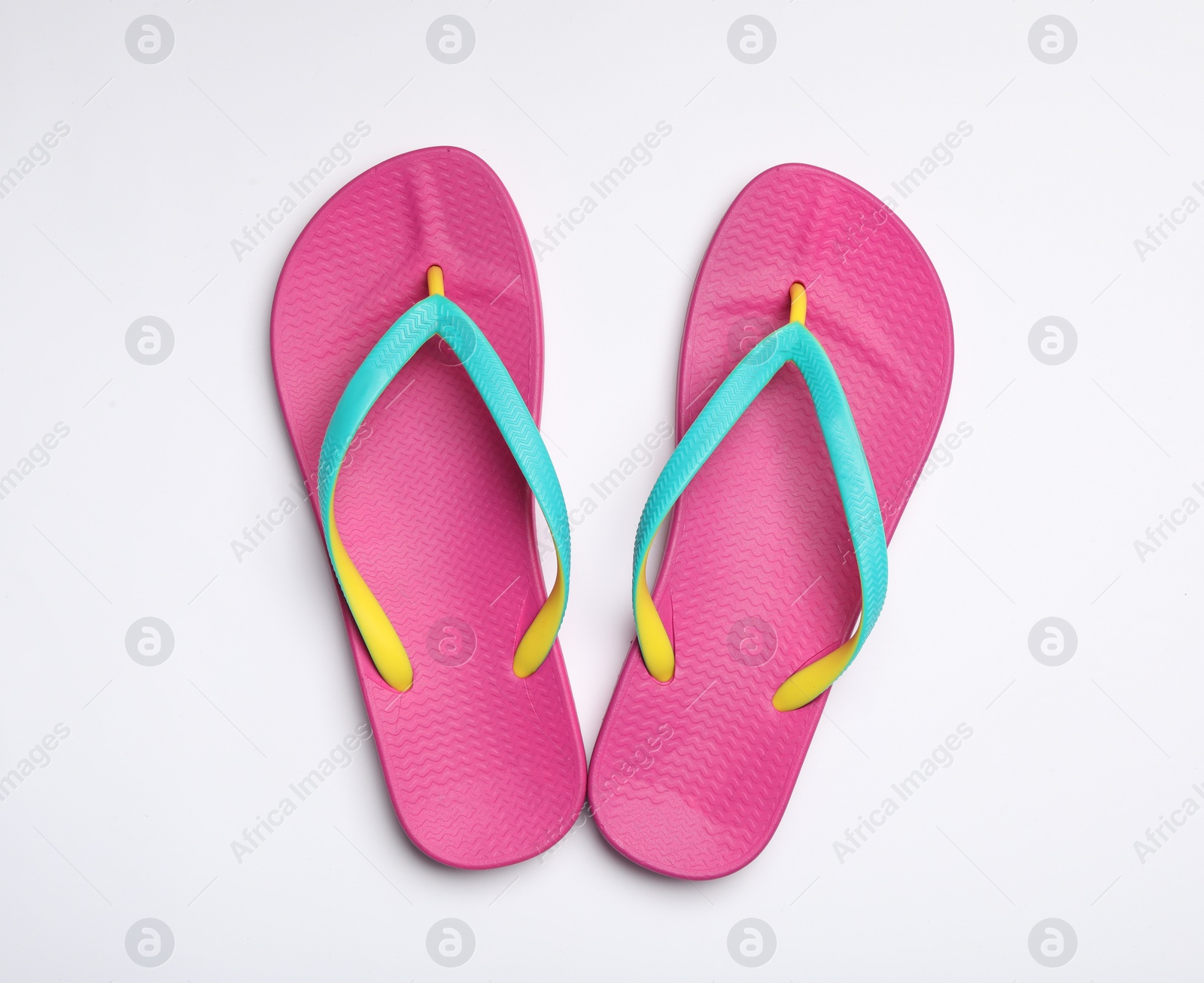 Photo of Pair of flip flops on white background, top view. Beach accessories