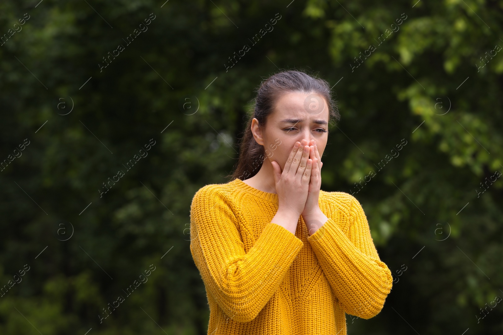 Photo of Woman suffering from seasonal spring allergy outdoors