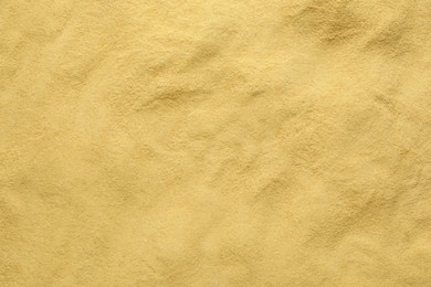 Photo of Granulated brewer`s yeast as background, top view