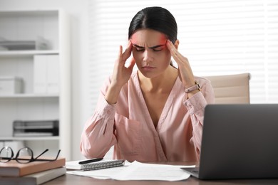 Image of Young woman suffering from headache in office