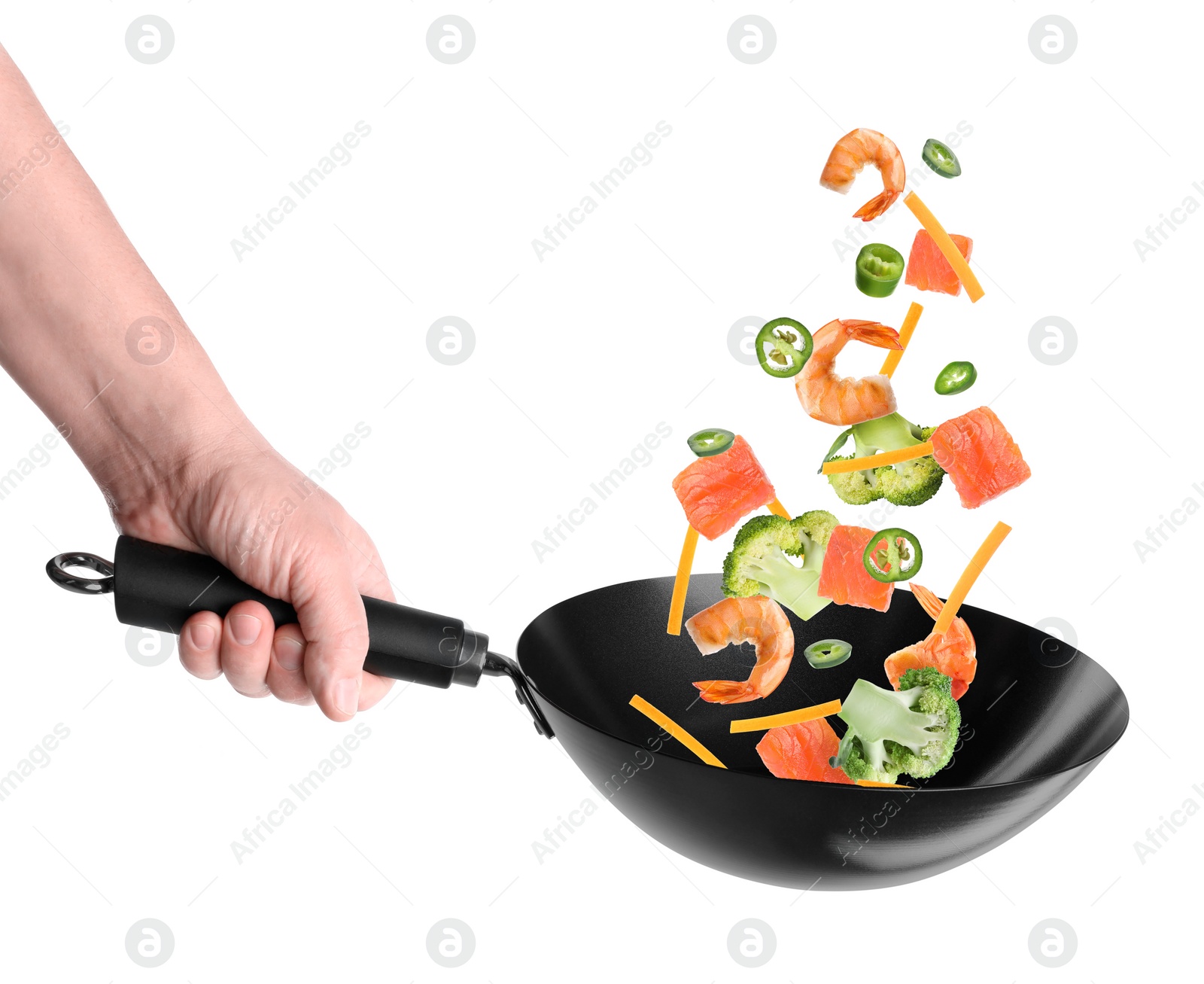 Image of Man tossing ingredients in wok on white background, closeup