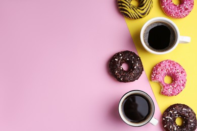 Photo of Tasty donuts and cups of coffee on color background, flat lay. Space for text