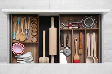 Photo of Drawer with utensil set, top view. Order in kitchen